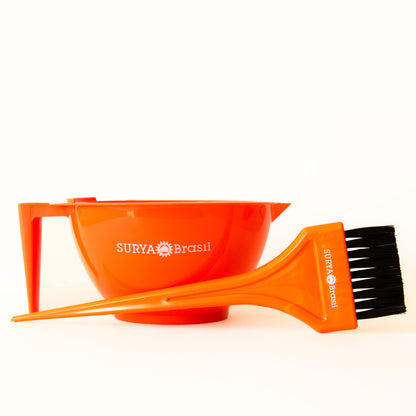 A graduated orange bowl and brush set for henna application, featuring black bristles and a sleek design.